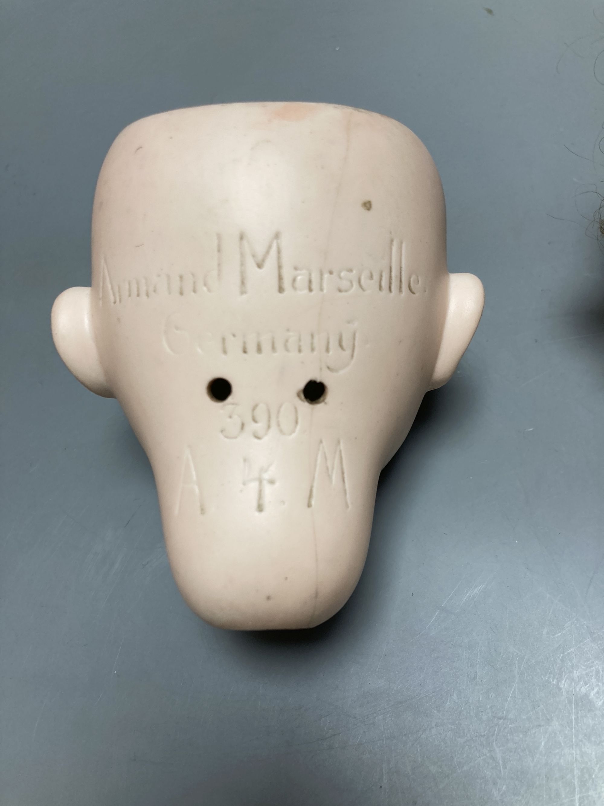 An Armand Marseille 390 bisque doll head, a Heubach Koppelsdorf bisque doll head and other